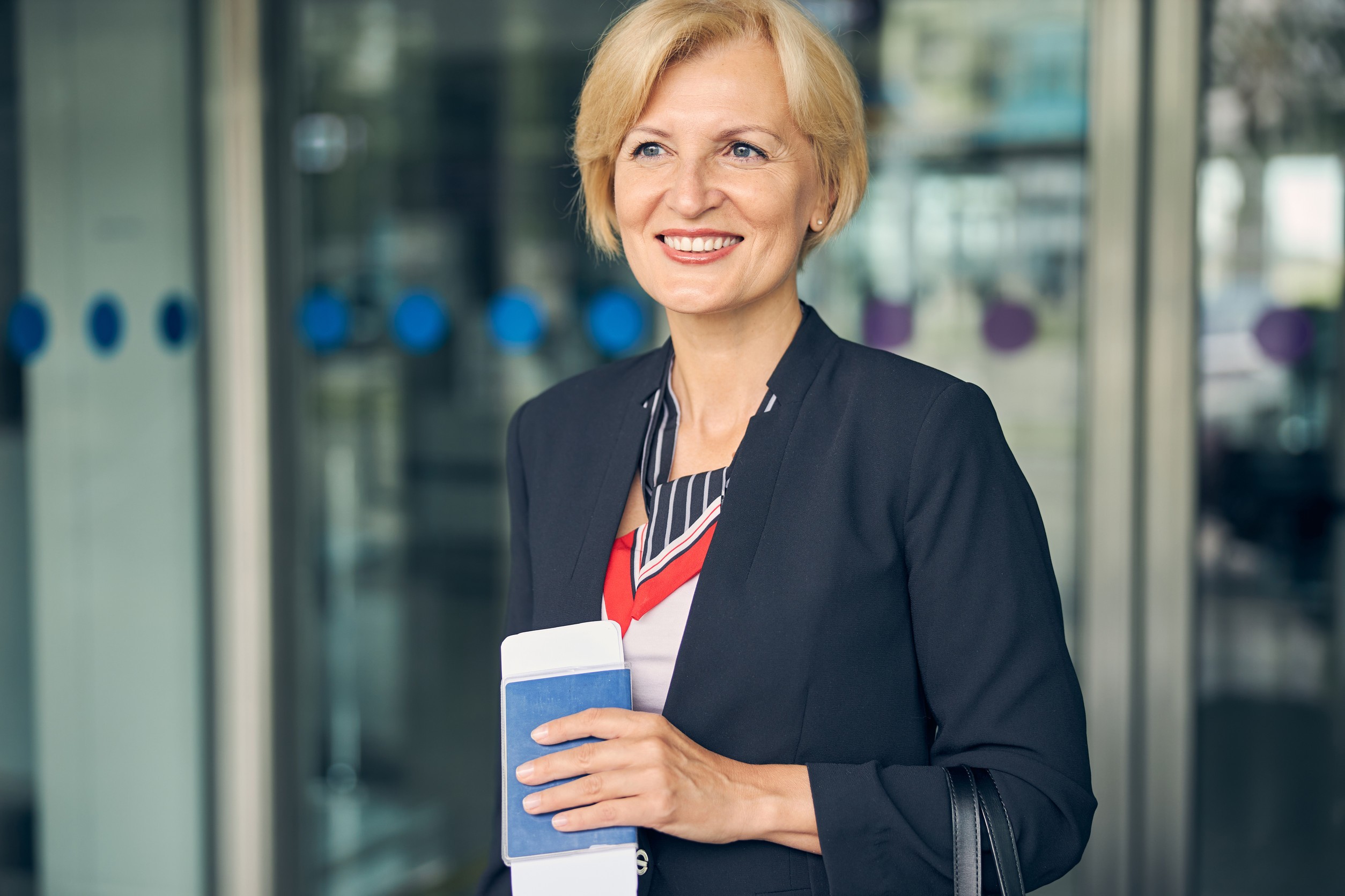 Business Woman Holding Airplane Ticket and Passport