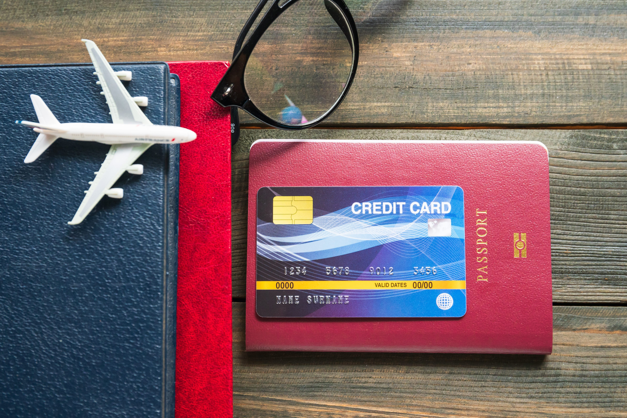 Credit card put on passport on wooden desk