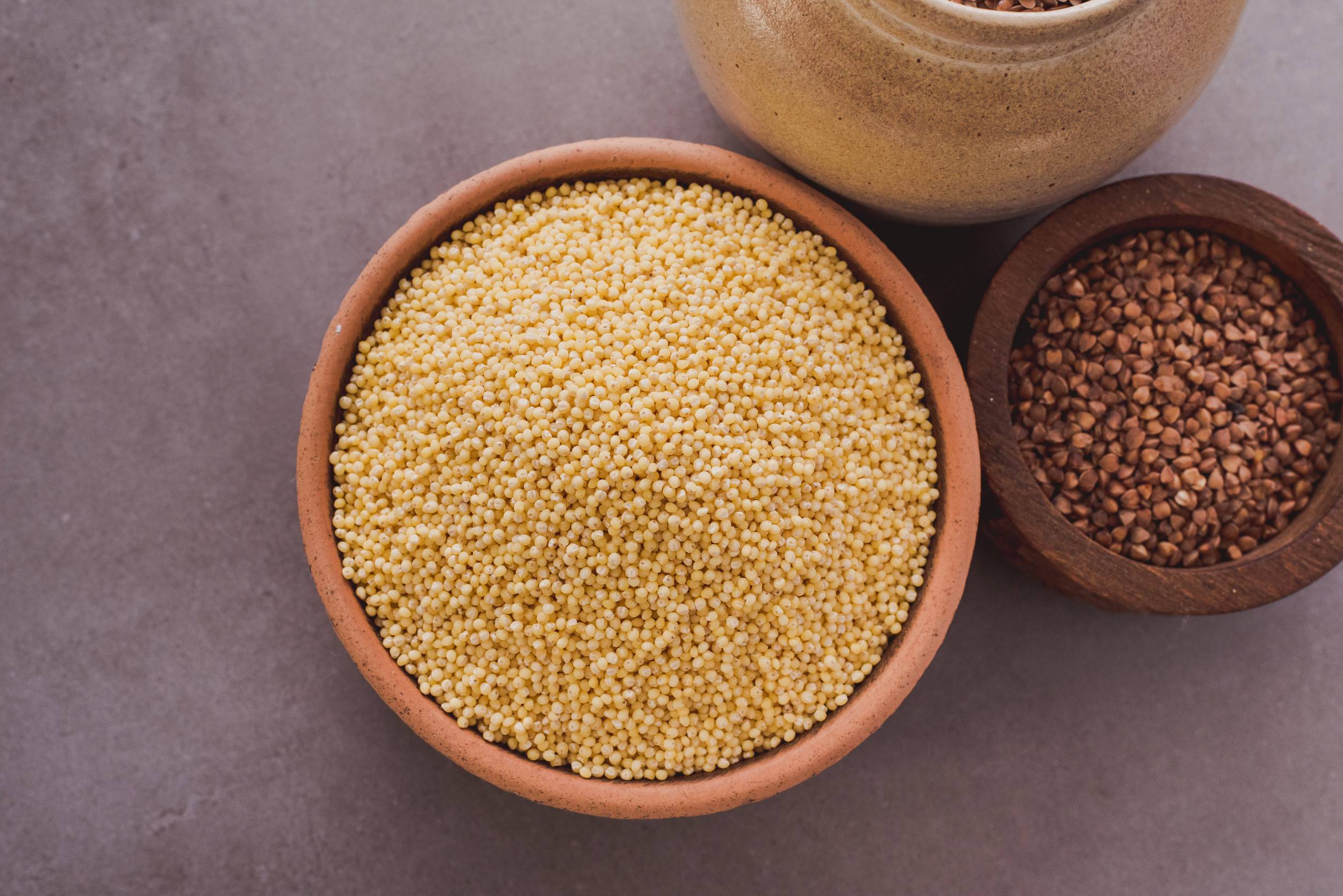 Millet And Sorghum Grains In Rustic Bowls