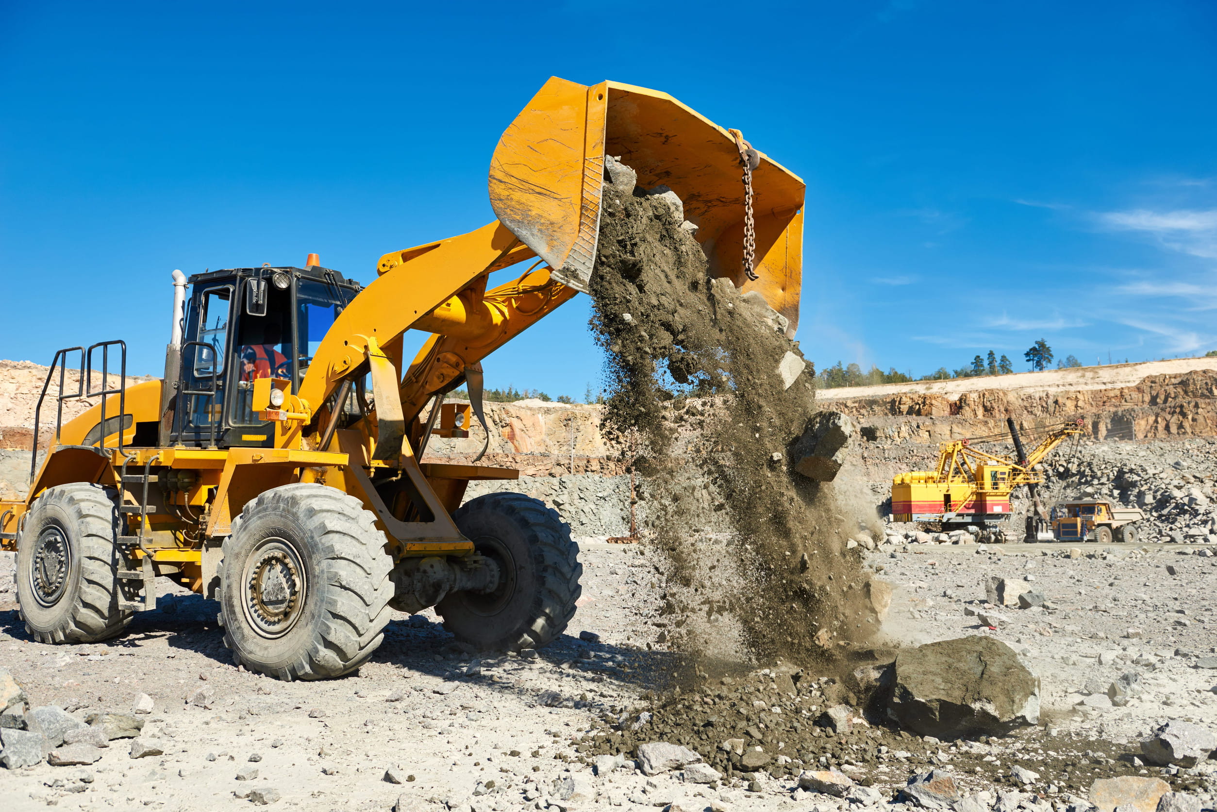 Mining and quarry workers operating heavy equipment at a mining site