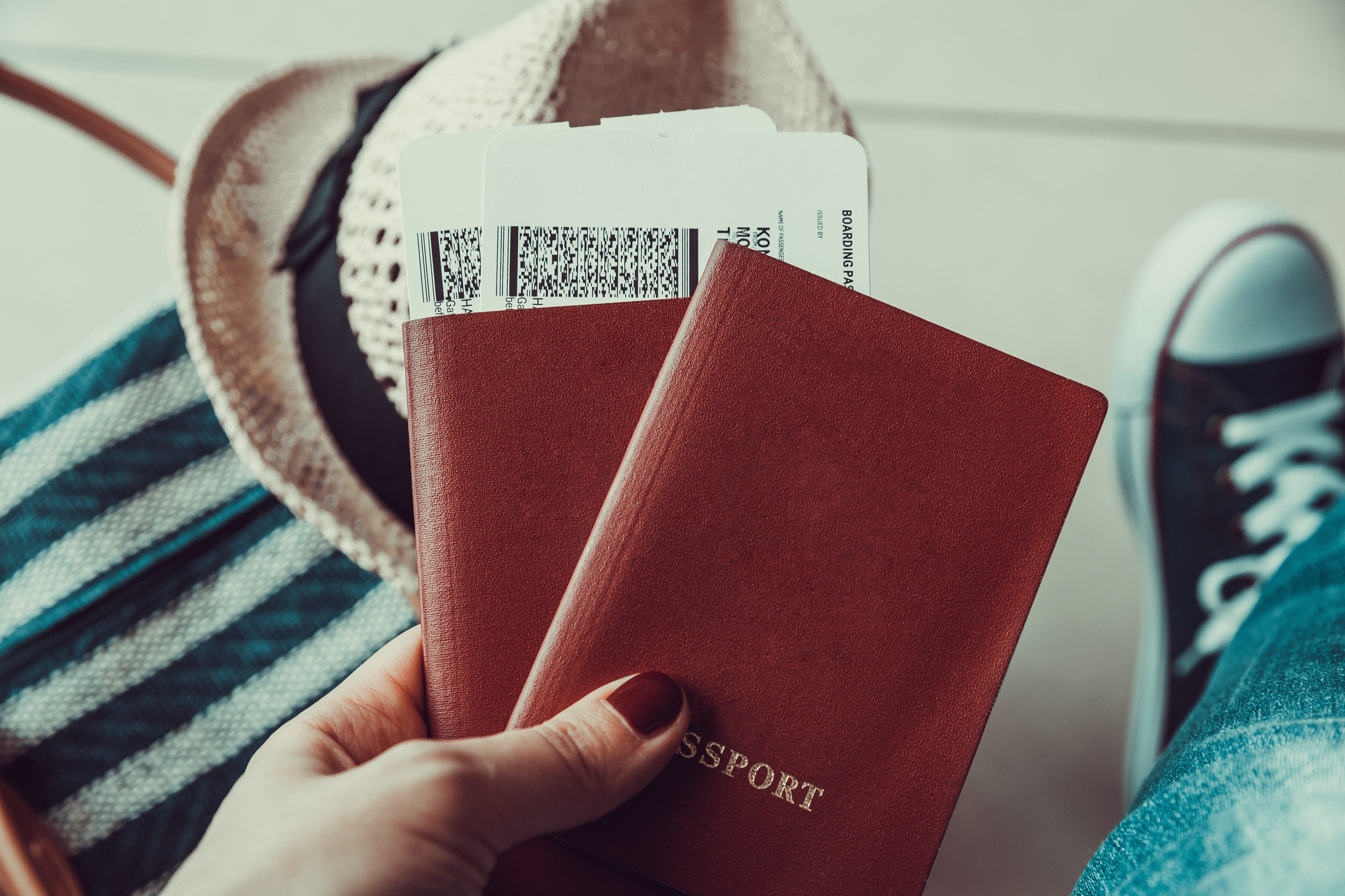 Woman holding passport and boarding pass