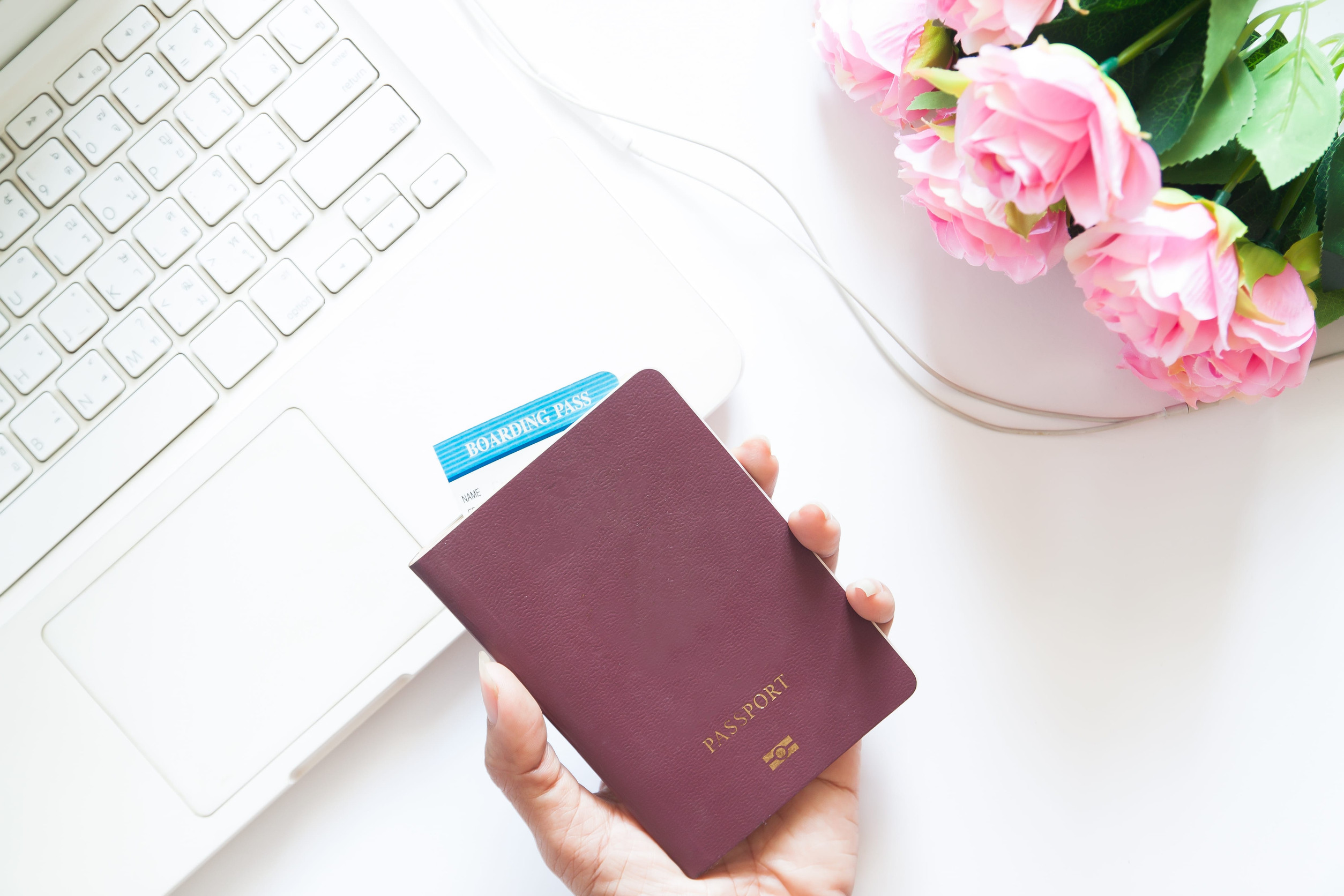 Women holding passport and using laptop